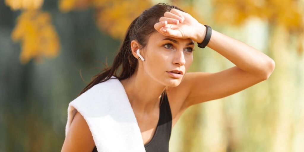 jogger wiping her forehead with back of hand