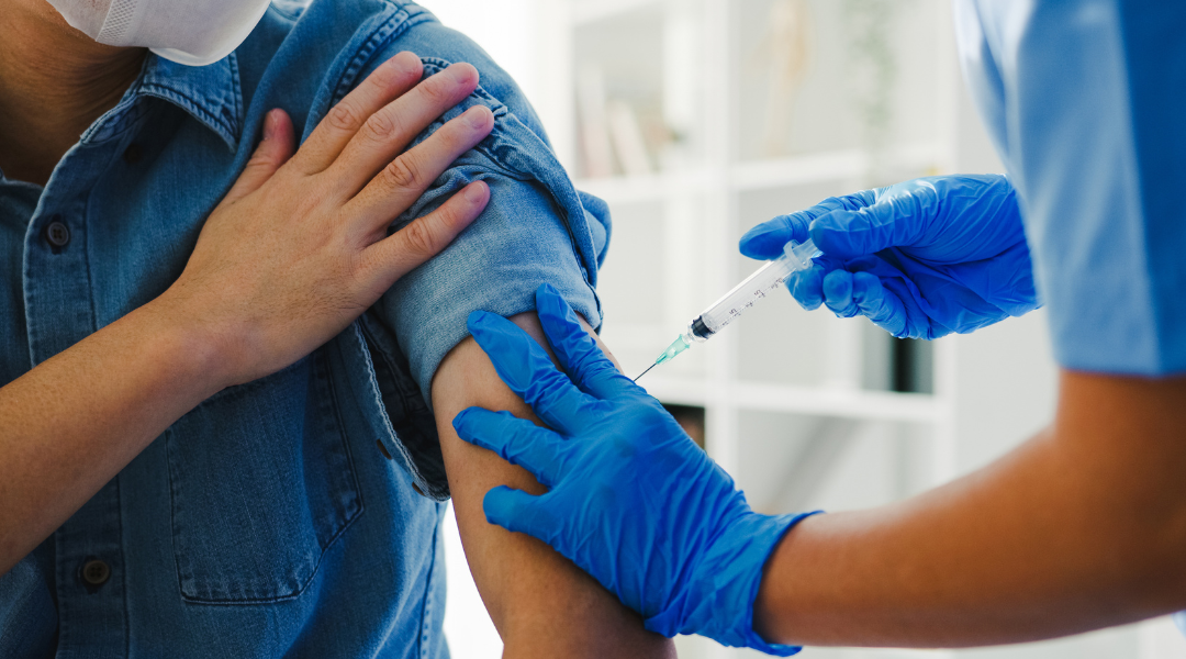 nurse giving flu vaccine shot