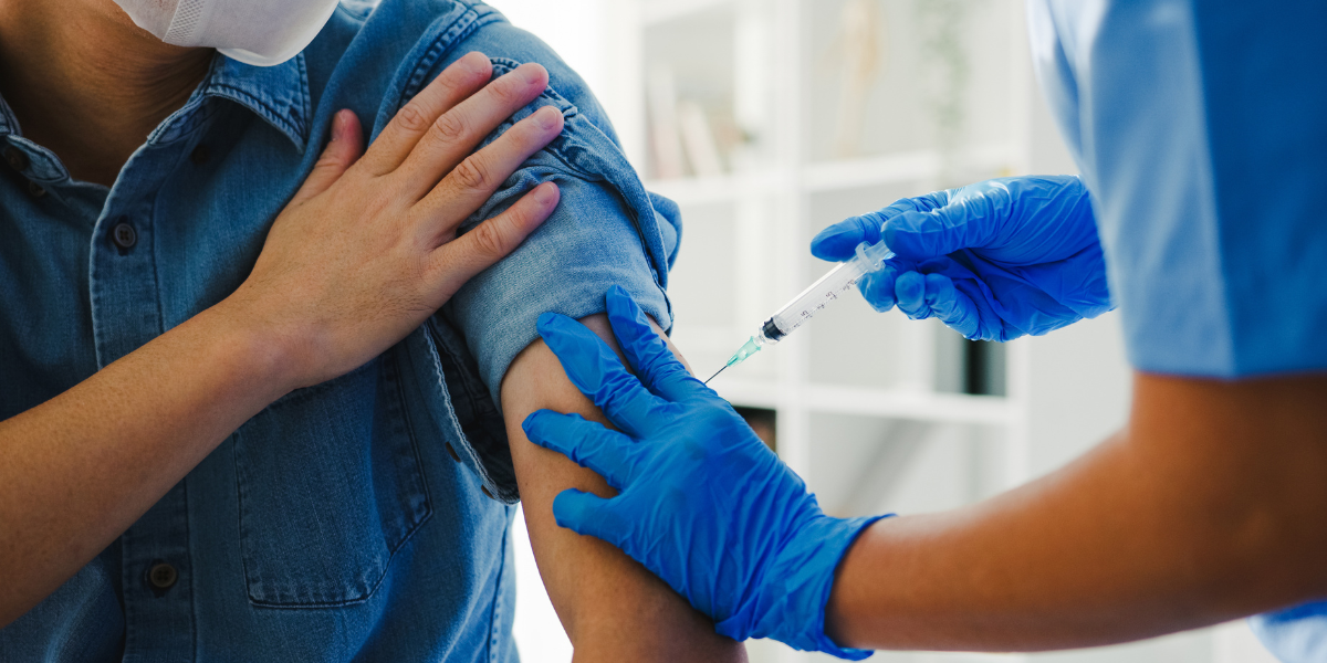 nurse giving flu vaccine shot