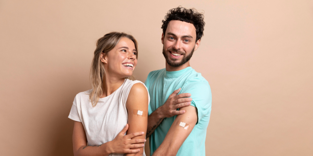 happy couple showing bandages from flu vaccine