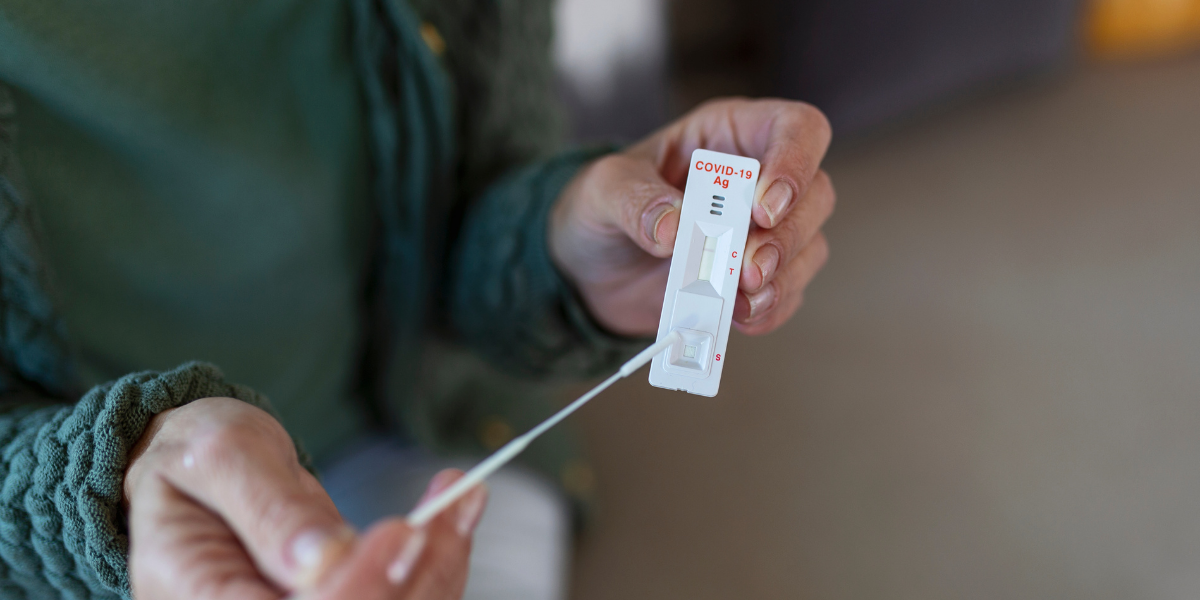 woman performing at-home COVID tests