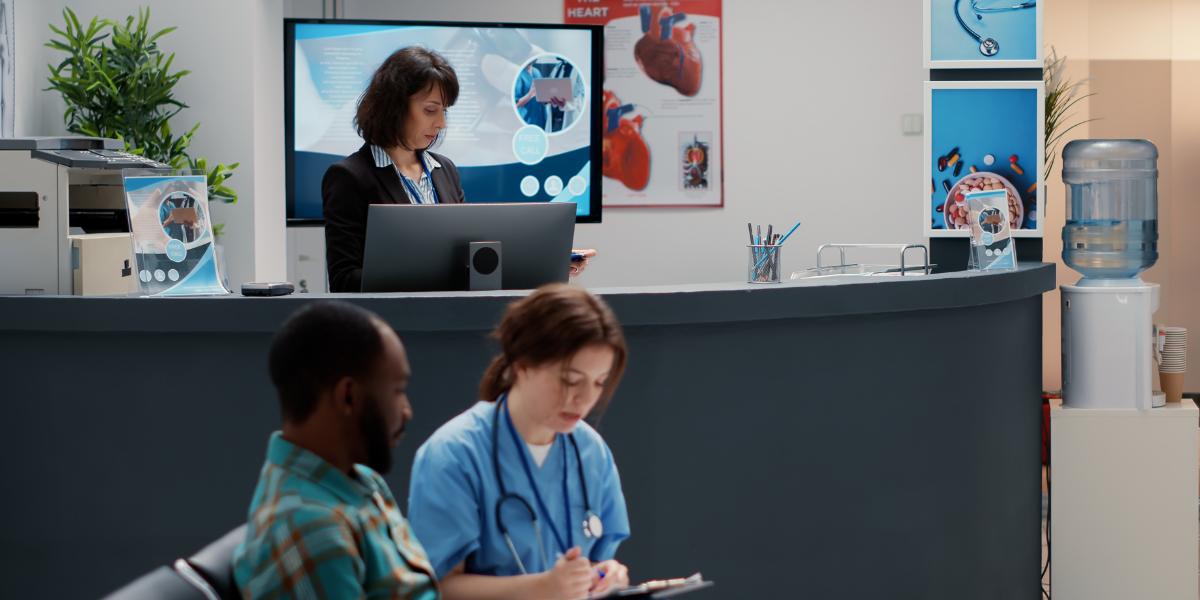 an employee, nurse, and receptionist in an on-site clinic lobby.