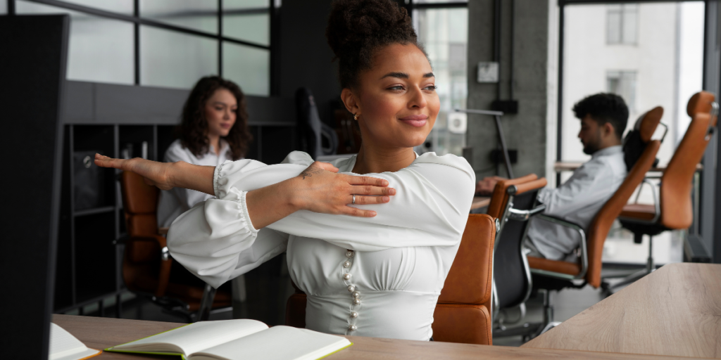 a woman at work stretching performing workplace wellness program examples