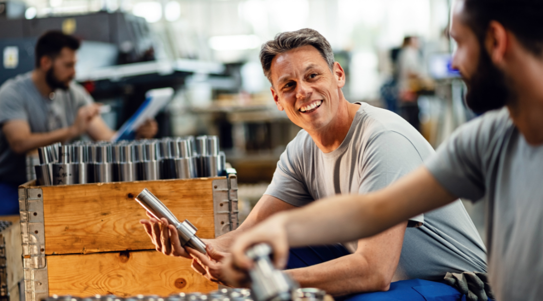 Two happy steel workers preparing manufacture product