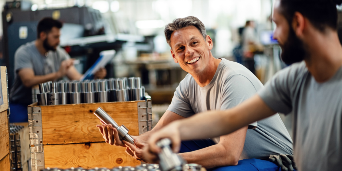 Two happy steel workers preparing manufacture product