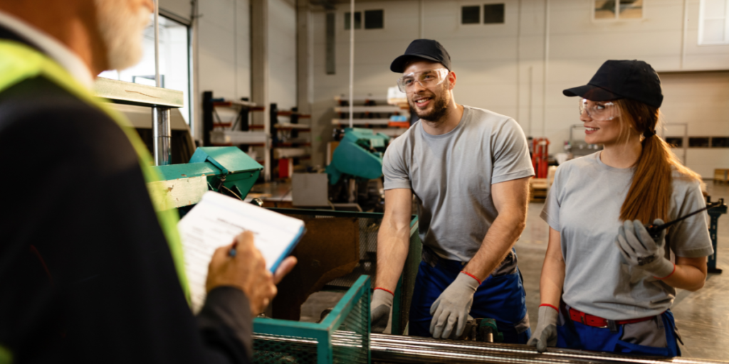 two happy manufacturing workers talking to someone