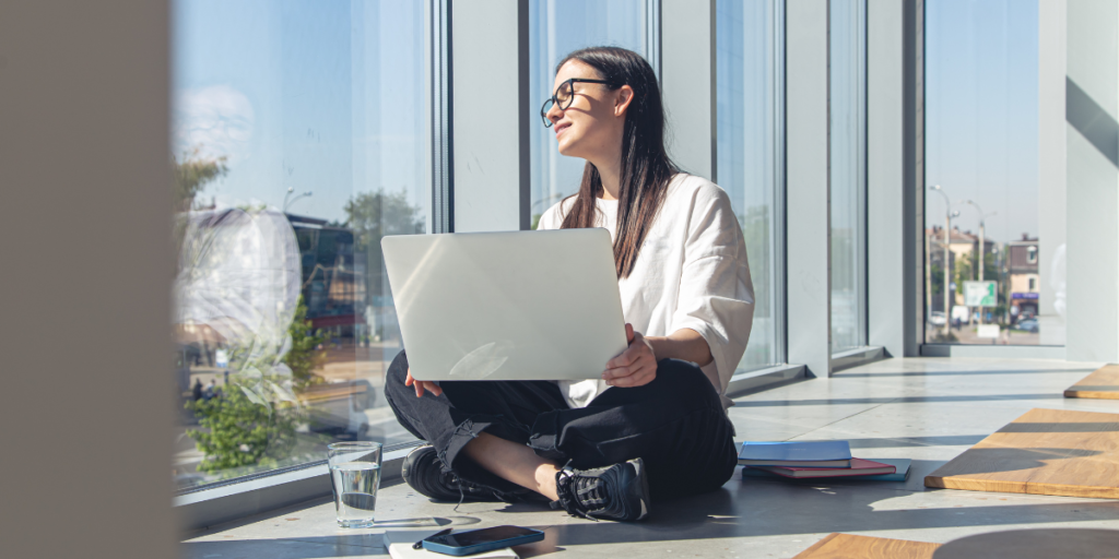 a woman in a relaxed area by he windows 