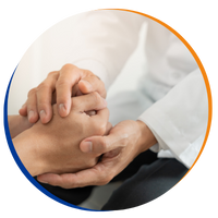 A healthcare professional comforting a patient by holding their hands