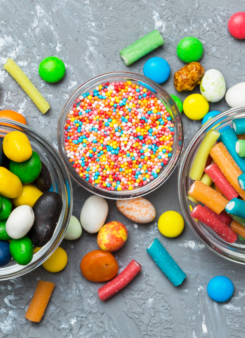 different-colored-round-candy-in-bowl-and-jars-to-2025-03-10-16-26-25-utc different colored round candy in bowl and jars. Top view of large variety sweets