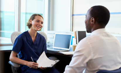 nurse talking to male employee in office